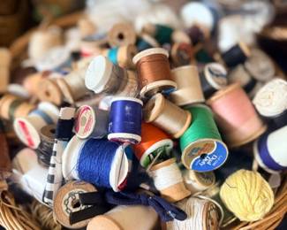 Basket of vintage wooden thread spools
