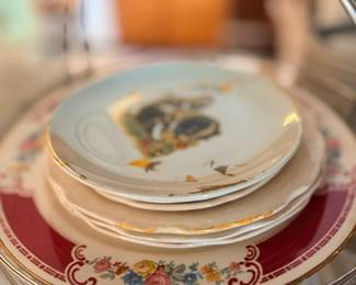 Stack of mismatched vintage china dessert plates