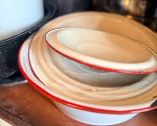 Vintage red-trimmed enamelware bowls stacked