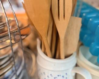 Wooden kitchen utensils in ceramic mug holder