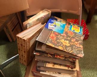 Folding chair with stack of books and magazines