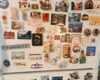 Large collection of travel souvenir refrigerator magnets