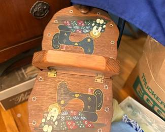 Vintage wooden sewing box with sewing machine motif