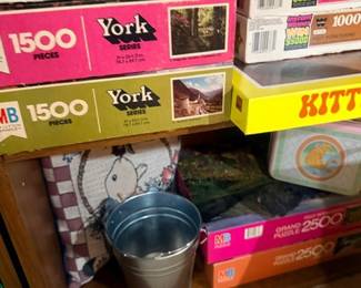Vintage jigsaw puzzles and small metal pail