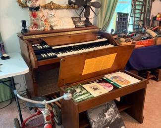 Vintage electric organ, child's tricycle & Ansel Adams art