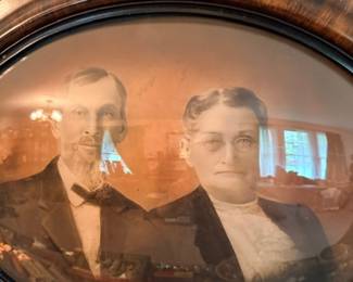 Antique Victorian couple portrait in oval convex bubble-glass frame