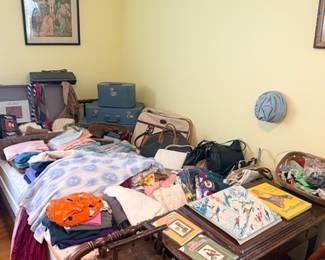 Table of vintage games, linens & luggage