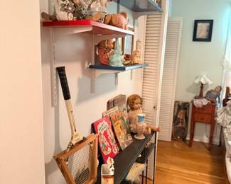 Wall shelves of porcelain dolls & collectibles