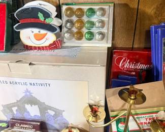 Snowman decor, brass candlesticks and nativity box