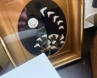 Oval gilt-framed mirror with bird decor