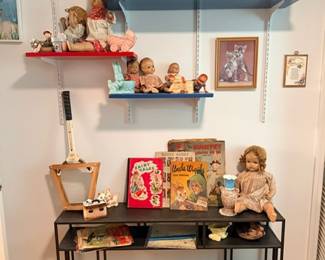 Antique dolls, vintage toys & children's books on shelves
