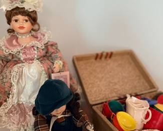 Collector porcelain doll & basket of vintage toy dishes