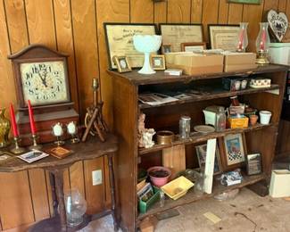Wooden shelf with vintage clocks and collectibles