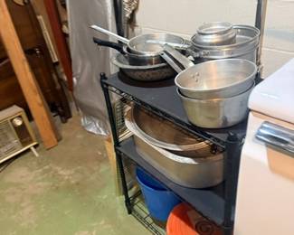 Metal shelving unit with pots and pans