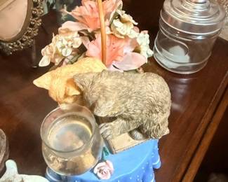 Furry cat figurine on decorative stand