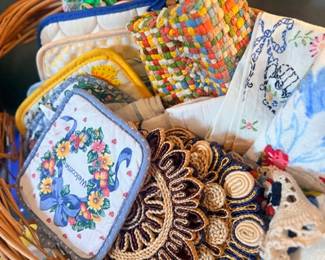 Basket of embroidered potholders and linens