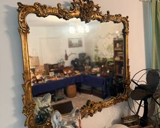 Ornate gilt rococo wall mirror & white cat figurine