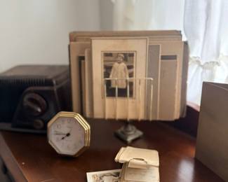 Vintage brass clock, old radio & antique photographs