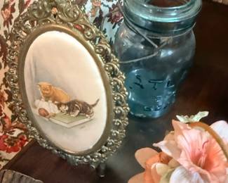 Ornate gilt frame with painted cat portrait
