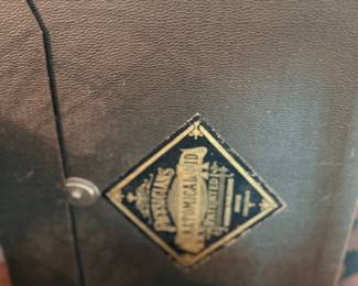 Antique leather case with brass maker's emblem