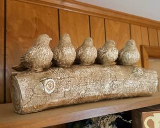 Ceramic bird figurines on log decor