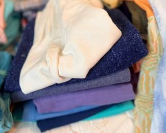 Stack of vintage folded sweaters & clothing