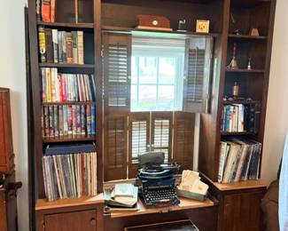 Built-in bookcase of books & vintage typewriter