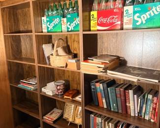 Cubby bookshelf with books and vintage soda bottles