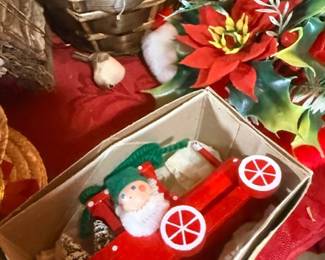 Elf and Santa figures with poinsettia decor