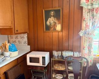 Kitchen with dishes, microwave & table