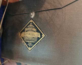 Antique leather case with brass maker's emblem
