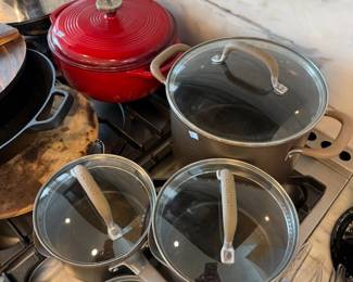 Red enameled Dutch oven and stainless cookware