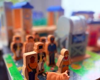Wooden toy figures and play buildings