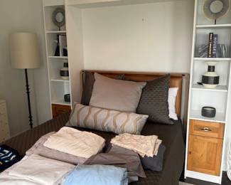 Upholstered bed with built-in shelving