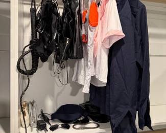 Women's clothing, belts and accessories in closet