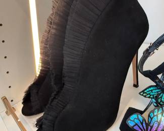 Black suede ruffle booties and butterfly wing heels