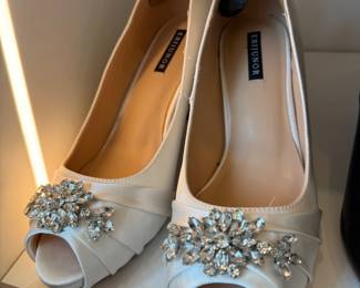 Ivory satin peep-toe pumps with crystal brooch
