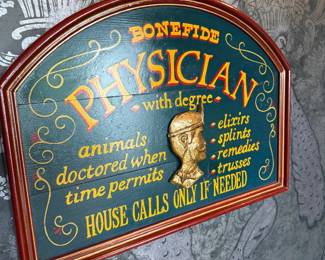 Framed vintage physician advertising sign