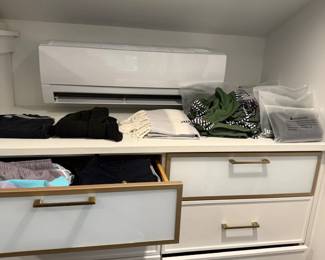 Folded clothing and accessories in closet drawers