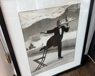 Framed black and white photograph, ice-skating waiter