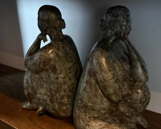 Pair of bronze-tone crouching figure sculptures