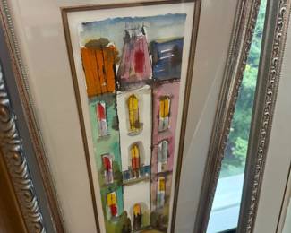 Framed watercolor of colorful row houses, silver frame