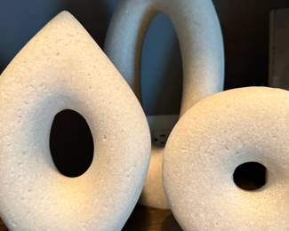 White stone sculptural donut forms