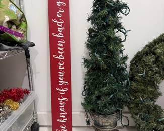 Artificial Christmas trees and holiday sign