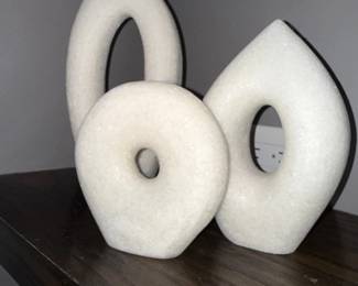 White stone donut sculptures, pair