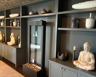 Built-in shelves with studio pottery and Buddha figures