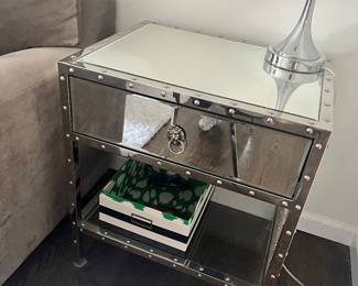 DETAIL OF THE MIRROR NAILHEAD END TABLE PAIR.