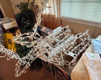 Two anamatronic lighted christmas deer, the prices are on the boxes
