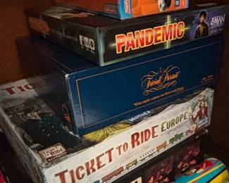 Collection of Board Games Pandemic, Trivial Pursuit, Ticket to Ride Europe, Simon, Tangooes, and Hummer SUT Sport Tow Team