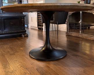 Arhaus Pedestal Dining Table with Wood Top. Measures 55" D x 30" H with 28" Clearance. Photo 1 of 8.